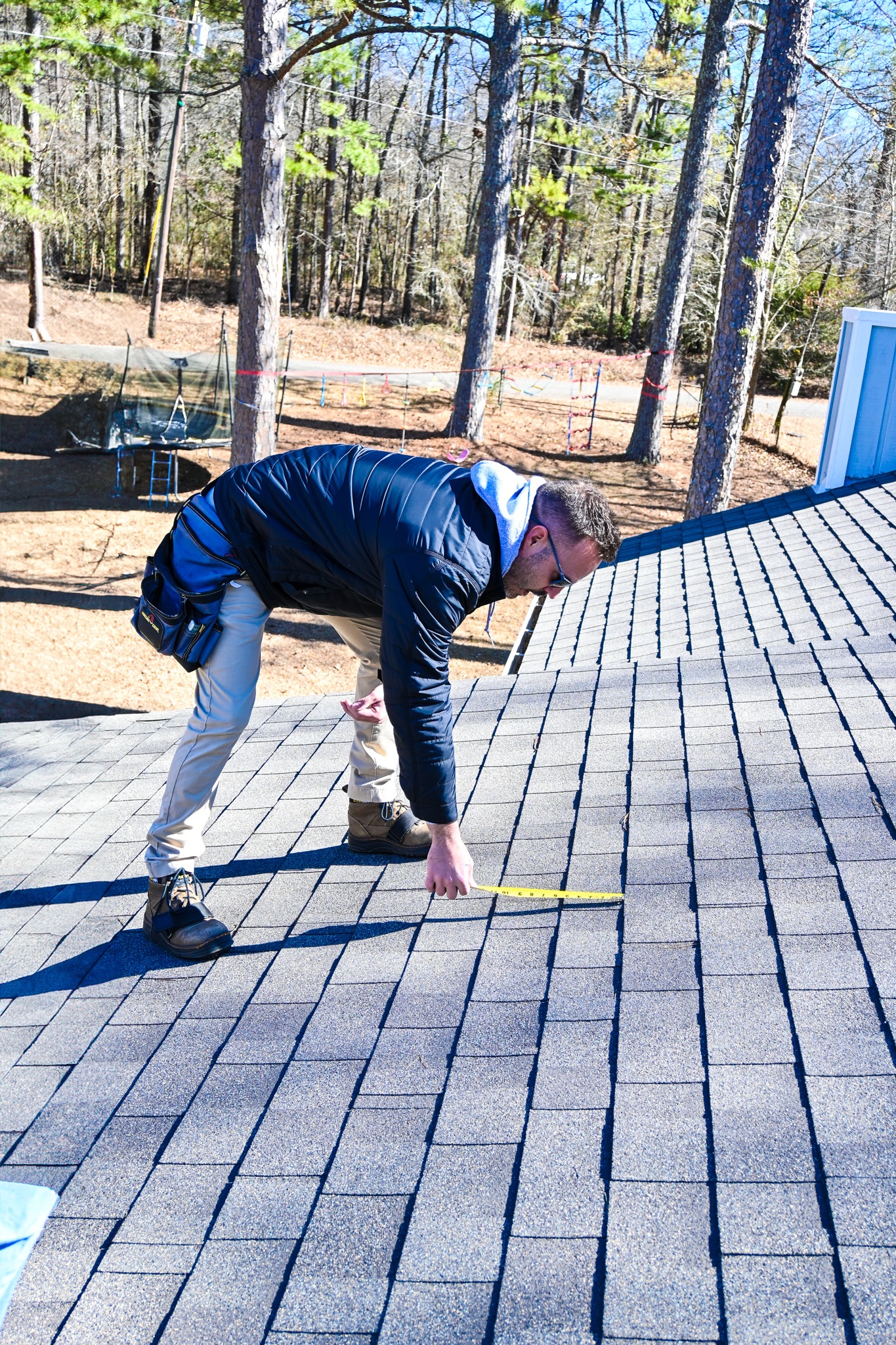 Ridgeline Roofing worker performing a roof inspection on the job