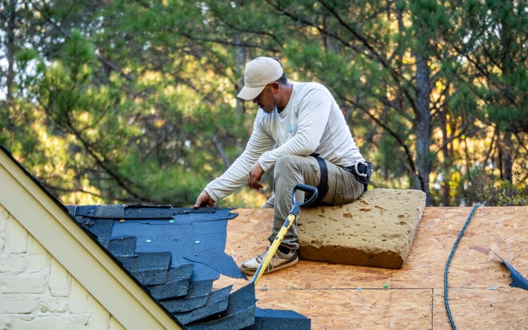Roofing professional inspecting an Alabama home for roof damage after a summer storm